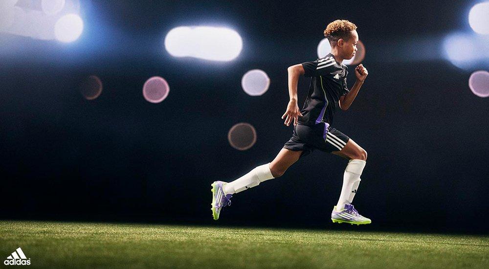 youth soccer player running in adidas soccer gear