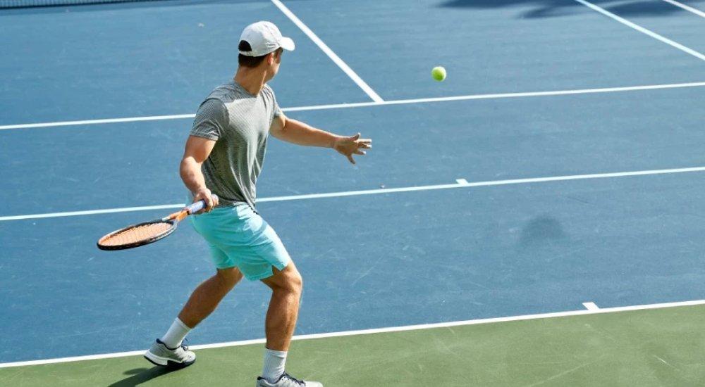 a man playing tennis on the court