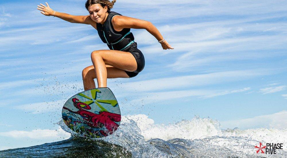 girl wakesurfing on a wakeboard