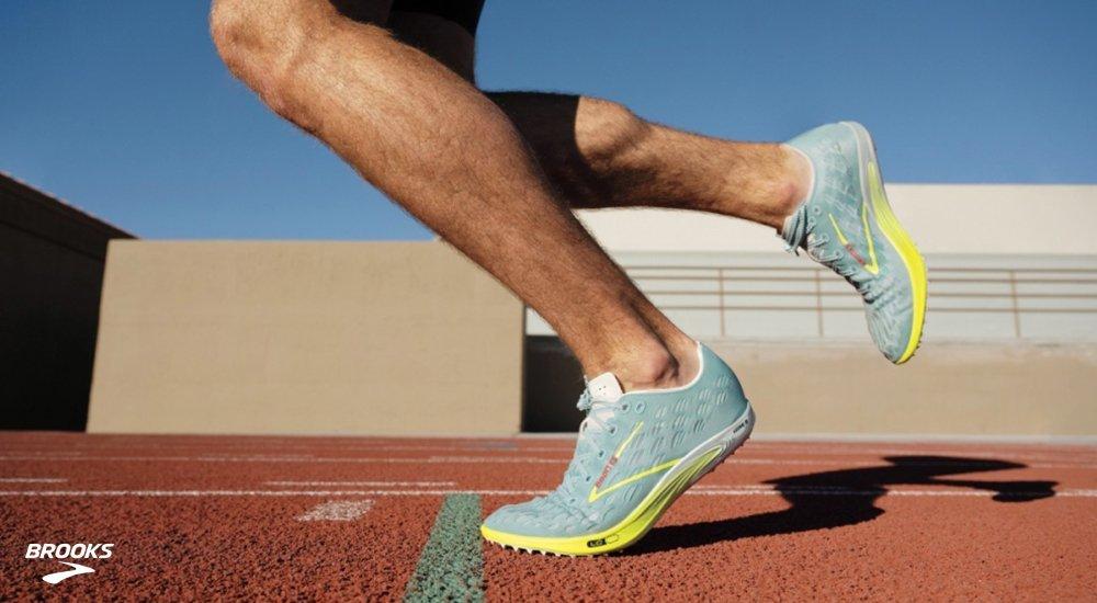A runner wearing Brooks track spikes