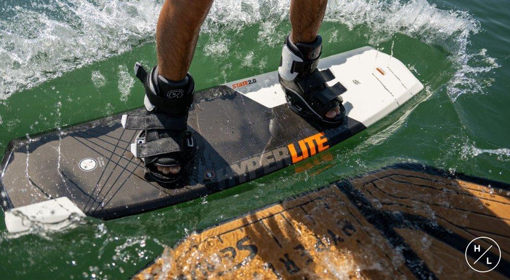 person wearing bindings on a wakeboard in the water