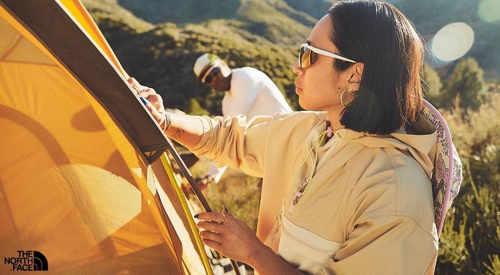 a girl cleaning off her camping tent