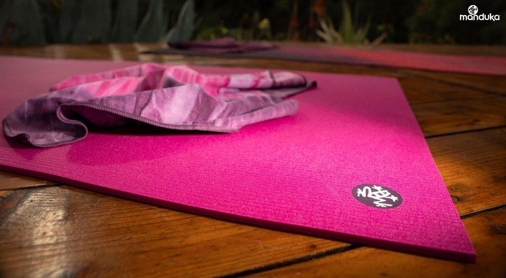 A Manduka yoga mat with a towel