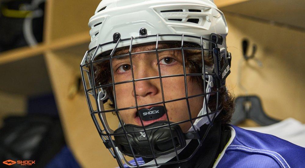 a hockey player in his gear in the locker room