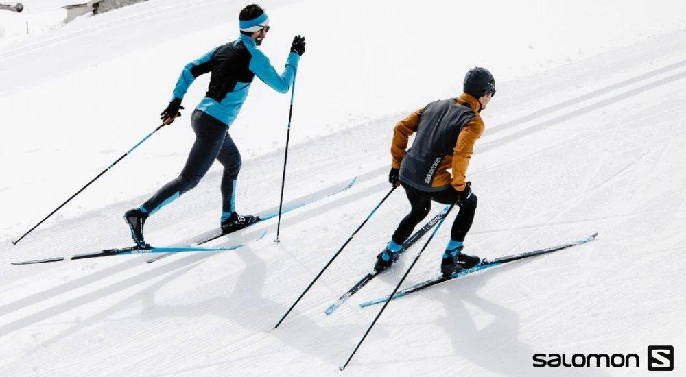 two people cross country skiing together