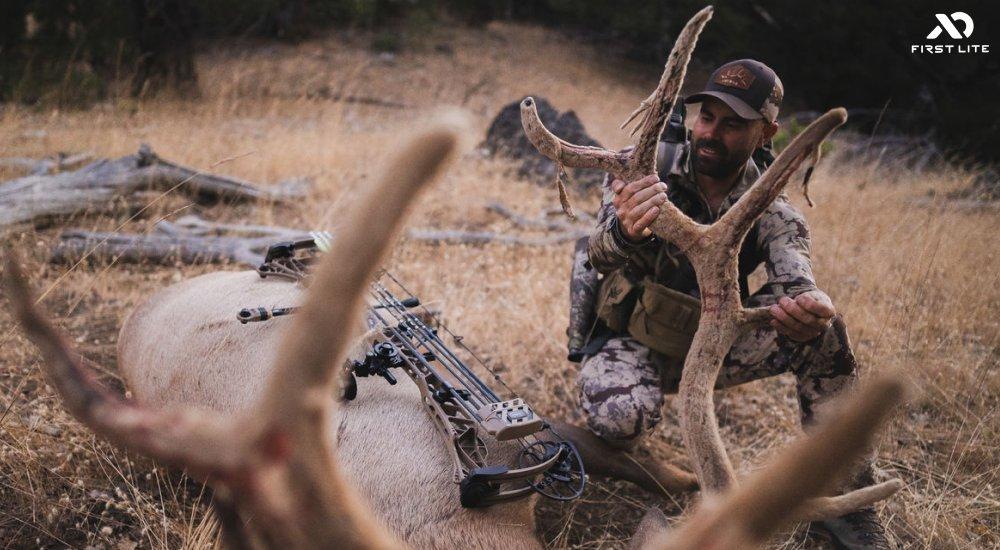 a man assessing his elk after his shot