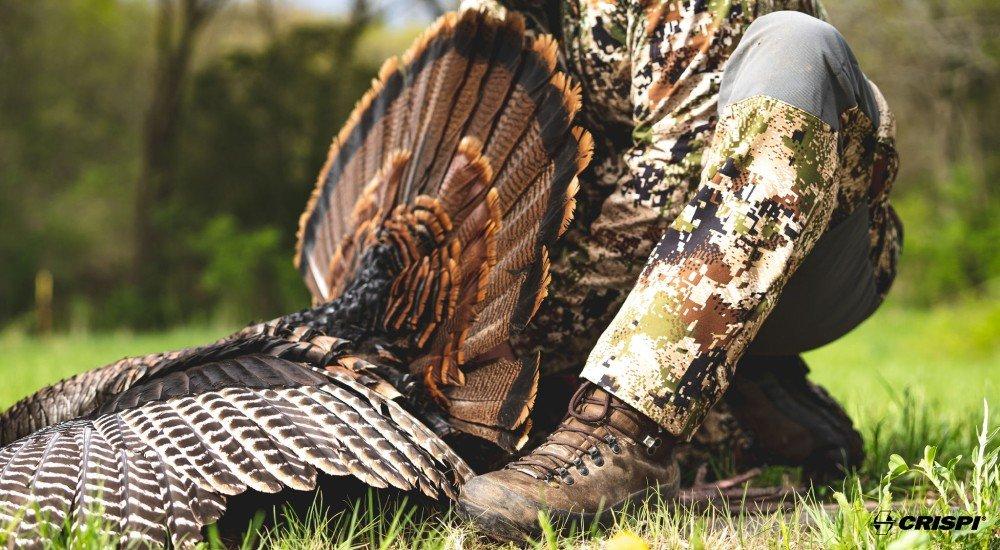 a turkey hunter wearing hunting boots in the field