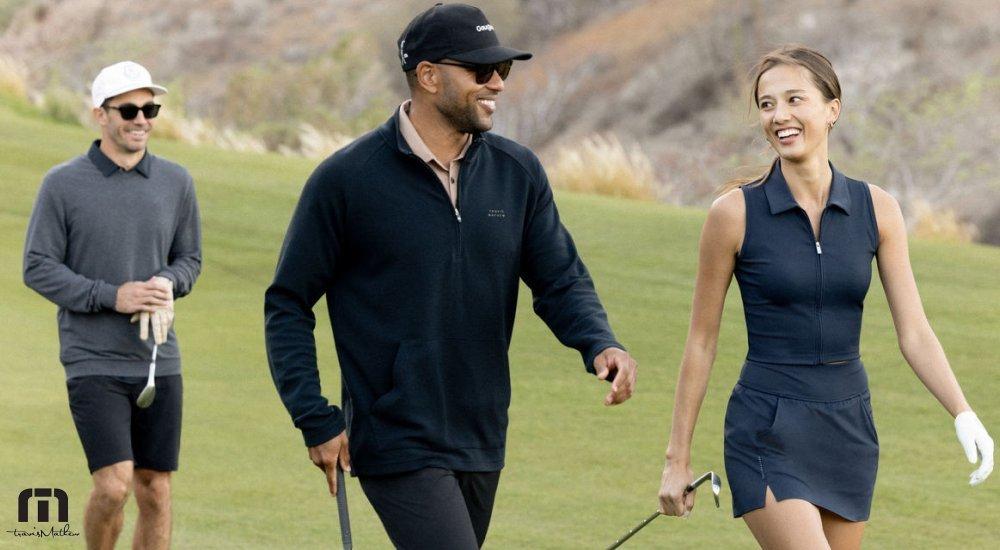 a group of three walking on the golf course