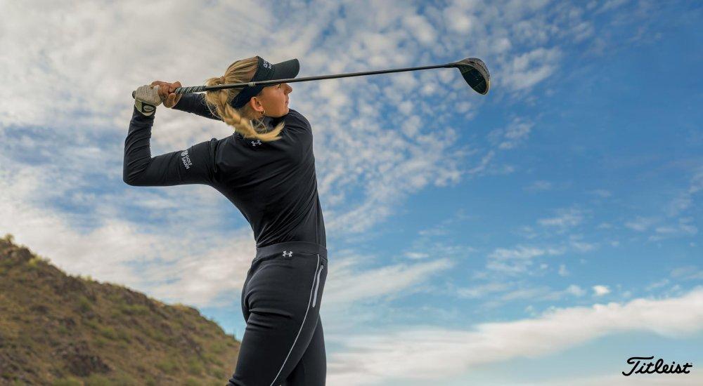 A female golfer swinging a club