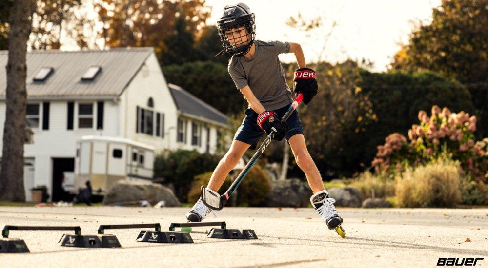 a player practicing hockey in his neighborhood