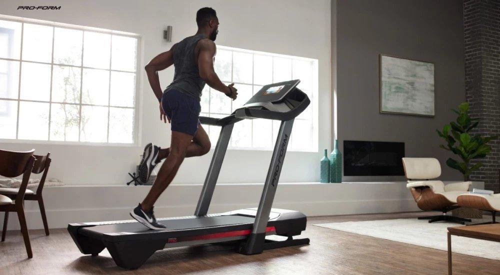 a man running on a treadmill in his home