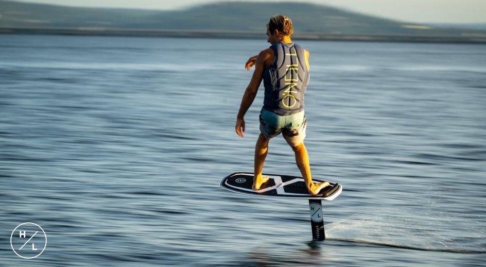 man foiling on a hydrofoil in the water