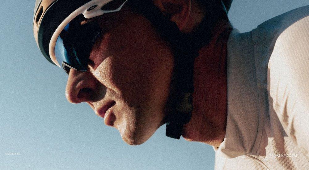 a guy wearing sunglasses while biking