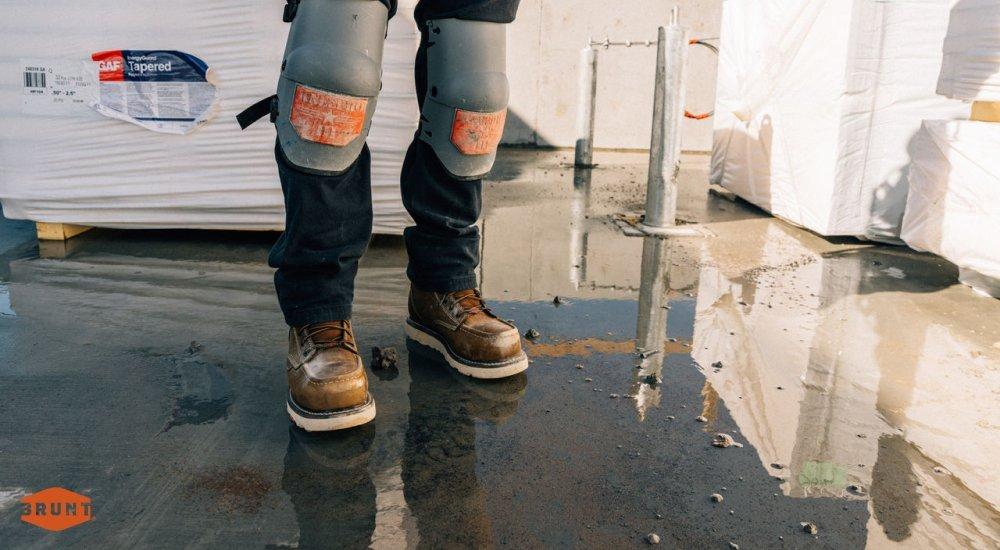 A worker wears Brunt non-slip work boots on a wet surface