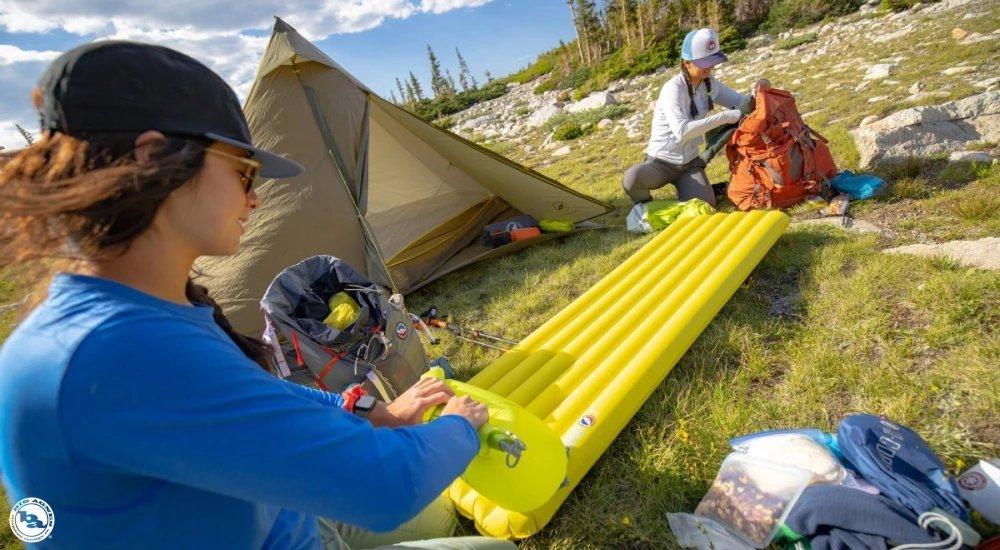 two women setting up their campsite