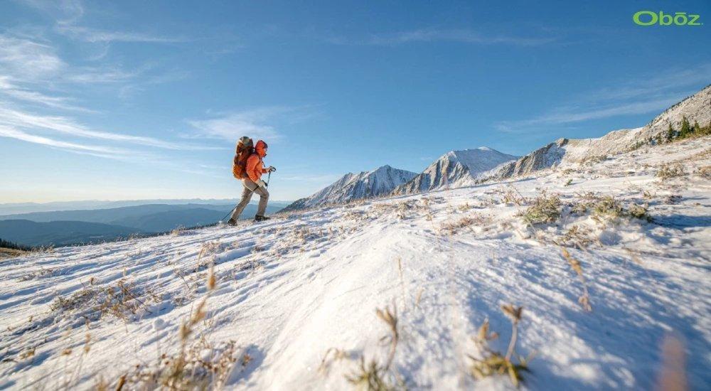 a hiker hiking up a snowy mountain