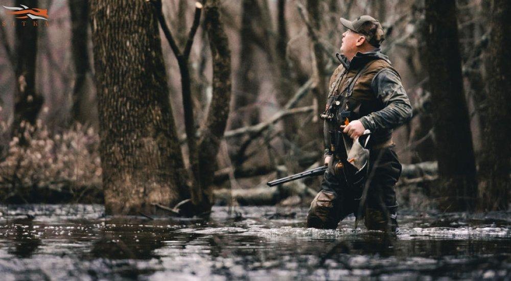 a man wading in the water with his hunting waders