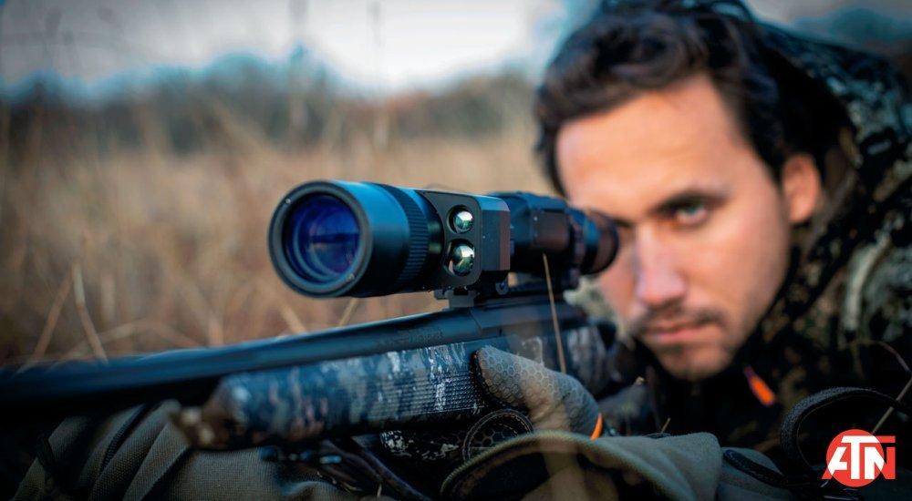 person looking through a thermal riflescope