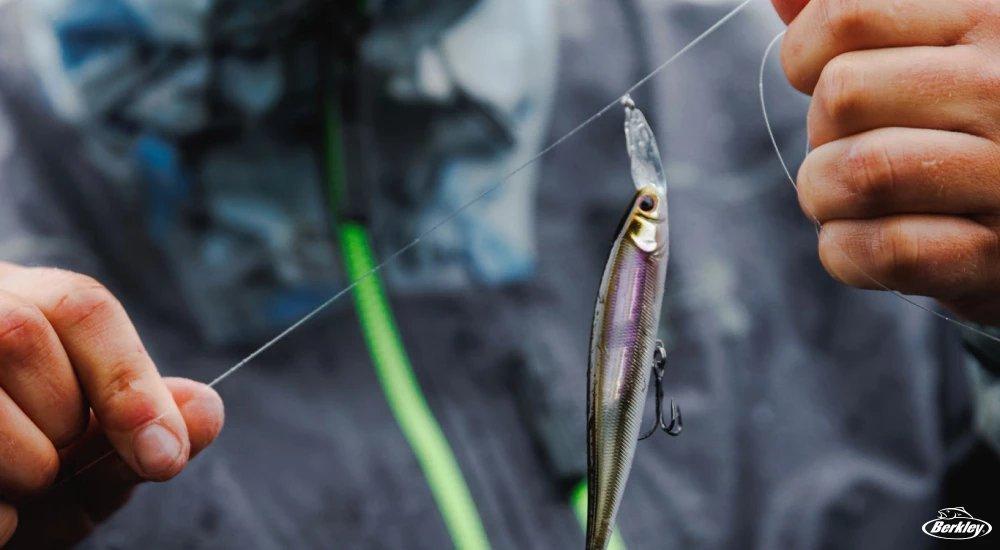 a man tying a fishing knot on monofilament fishing line