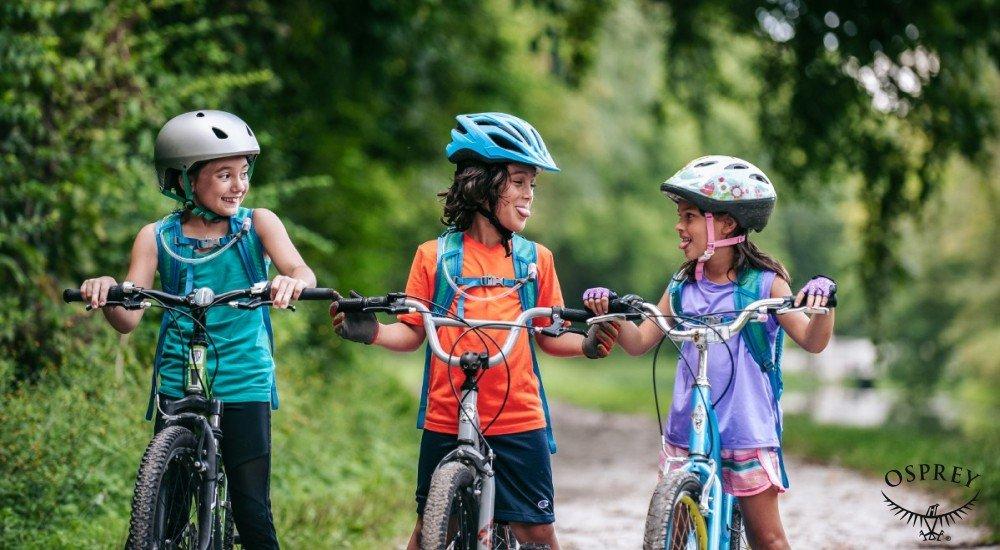 three kids riding a bicycle