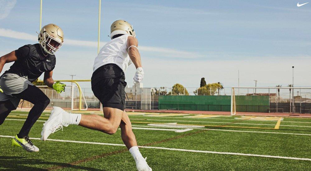 two players practicing football with some of their gear on