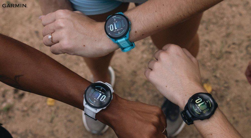 Wrists in a circle with Garmin fitness trackers