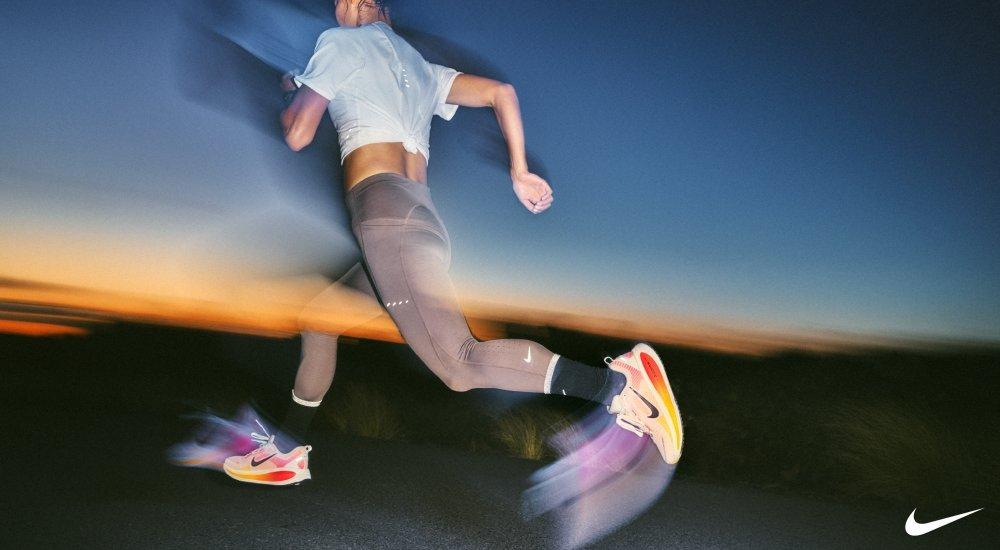 A person running at dawn in Nike running shoes