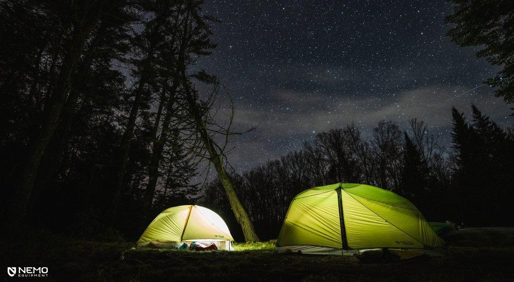 Two Nemo tents illuminated under the stars