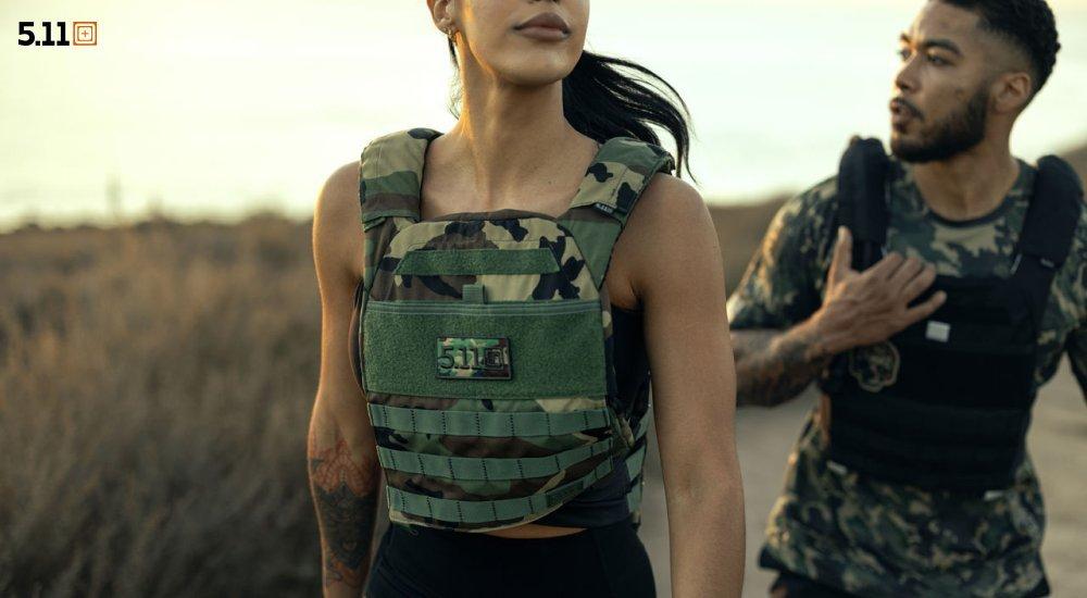 Two people wearing weighted vests outside