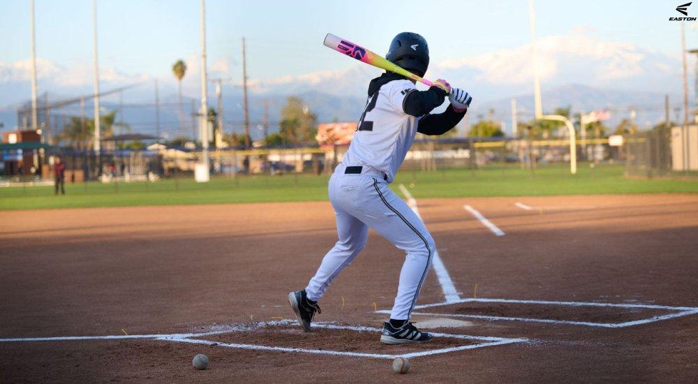 a youth baseball player swinging a composite bat on the field at practice