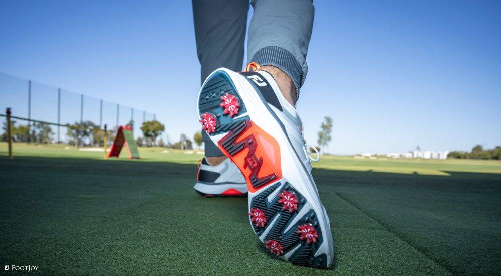 a golfer wearing spiked golf shoes from FootJoy