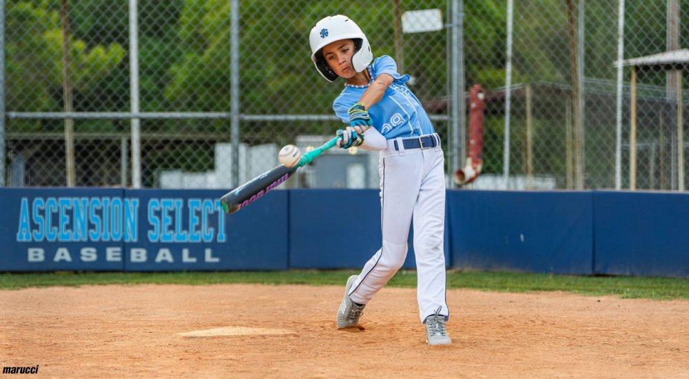 a young player hitting a baseball bat at home plate