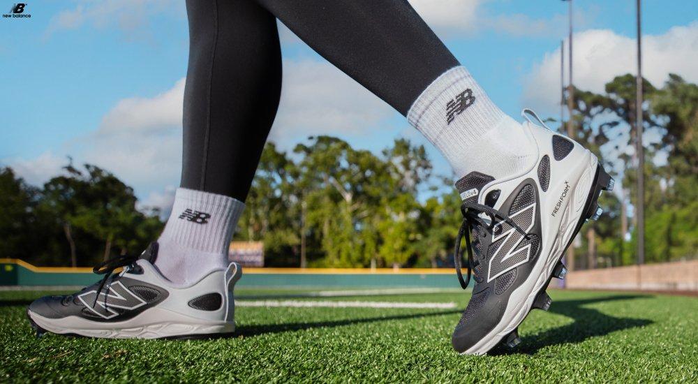 a player wearing a pair of New Balance softball cleats on the field