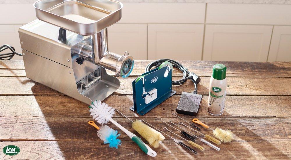 a meat grinder with cleaning supplies near it