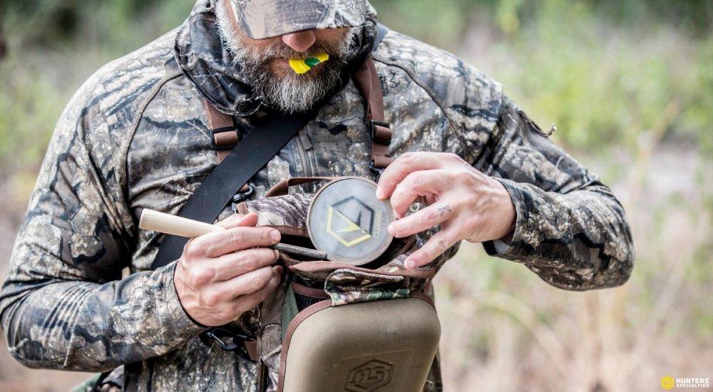 a hunter packing turkey calls into his bag