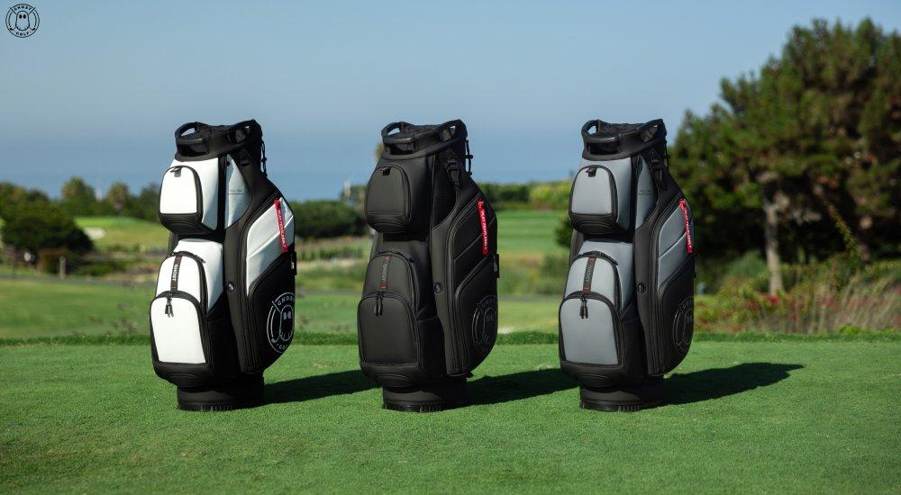 three ping golf bags lined up on the golf course