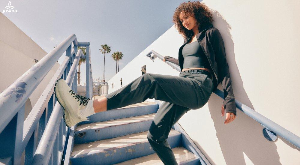 a woman wearing a pair of lightweight travel pants while on steps