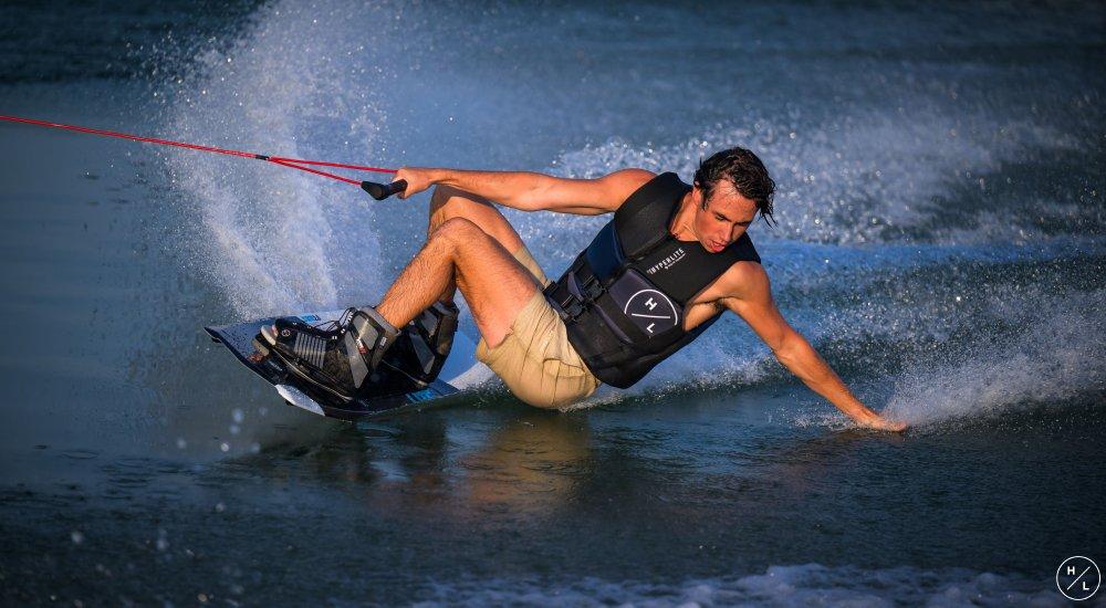 a man wakeboarding on the lake behind a boat