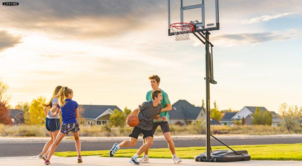 a family out playing basketball in their driveway
