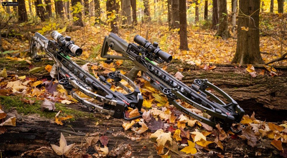 two crossbows with the complete crossbow package laying the woods