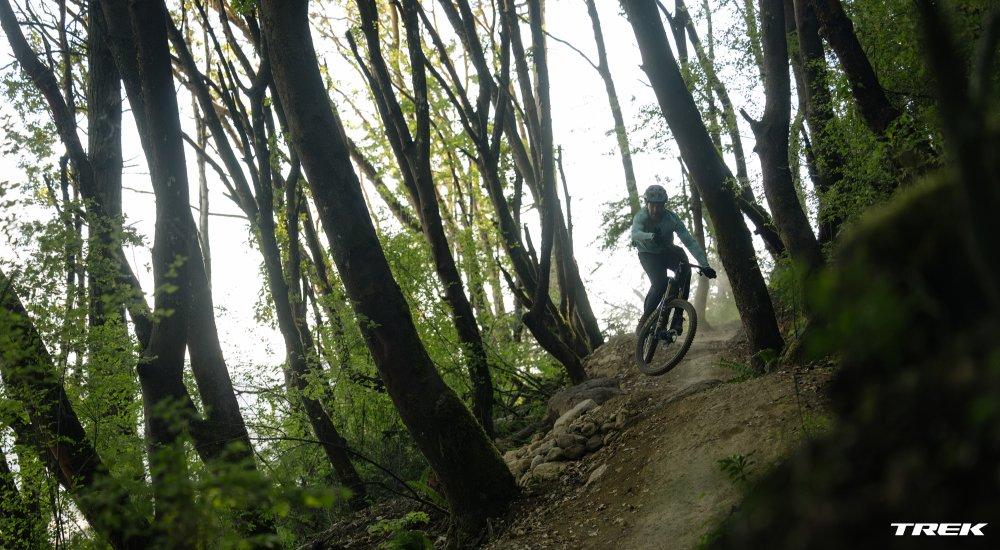 man on a mountain bike riding in a forest