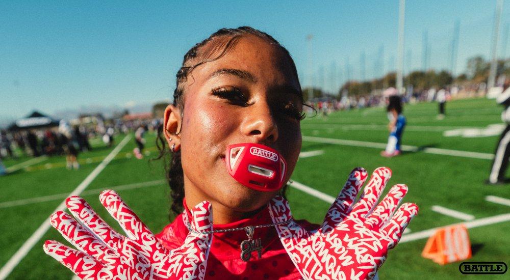 girl with a mouthguard in her mouth smiling at the camera