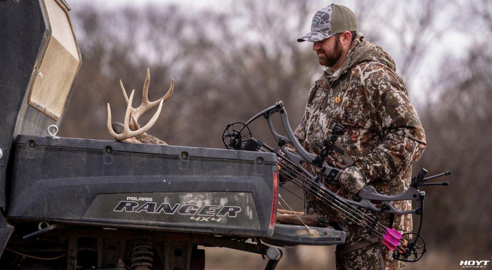 a hunter holding a compound bow 