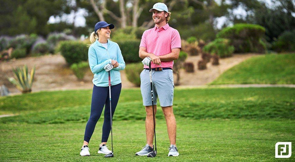 A male and female golfer standing together on a course