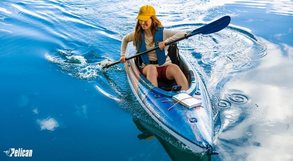person sitting in a kayak paddling on the water