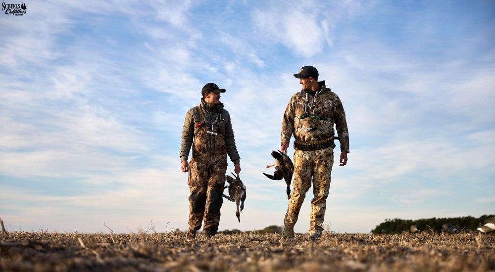 two men with geese in their 