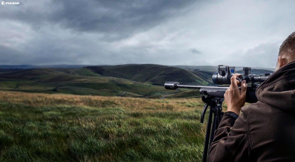 a hunter looking through a thermal optic 