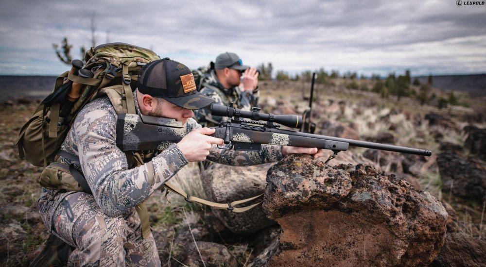 two hunters using optics when in the mountains