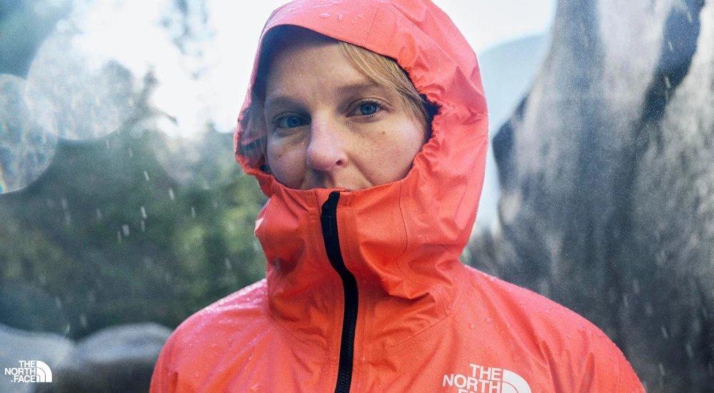 a woman with a north face jacket on in the rain