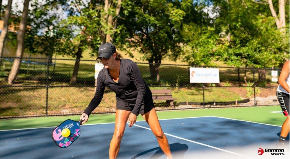 a woman playing pickleball